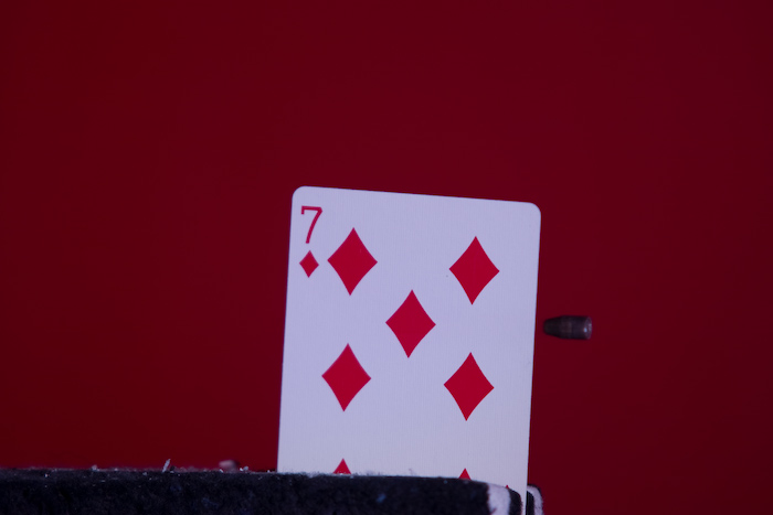 This was done with the help of my friend Christina who is currently pursing a PhD at MIT and in her spare time is the TA for the Strobe Project Lab...  That is a bullet just before striking the card.